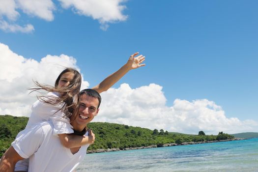 happy young couple have fun and relax  on the beach