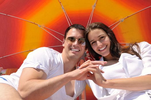 happy young couple have fun and relax  on the beach