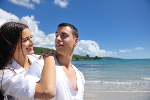 happy young couple have fun and relax  on the beach