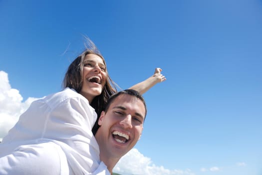 happy young romantic couple in love have fun running and relaxing on beautiful beach