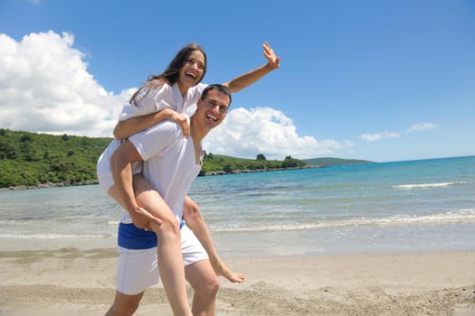 happy young romantic couple in love have fun running and relaxing on beautiful beach