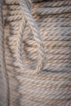 Background of jute rope on a reel close-up. Selective focus in blur.