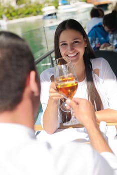 happy young couple having lanch at beautiful restaurant on by the sea on  beach