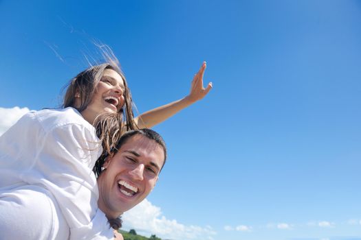 happy young couple have fun and relax  on the beach