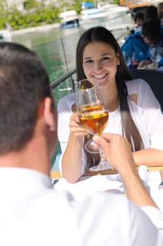 happy young couple having lanch at beautiful restaurant on the beach