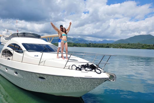 Romantic young couple spending time together and relaxing on yacht