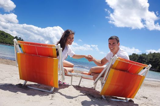 happy young couple have fun and relax  on the beach