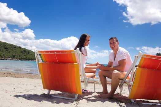 happy young couple have fun and relax  on the beach