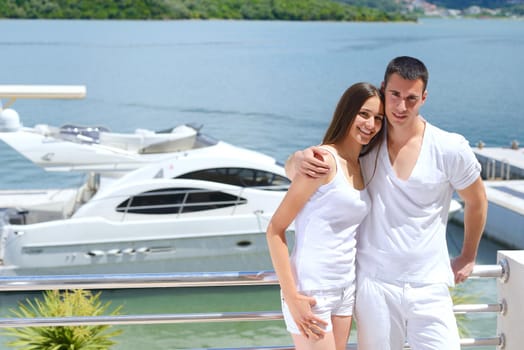 Romantic young couple spending time together and relaxing on yacht