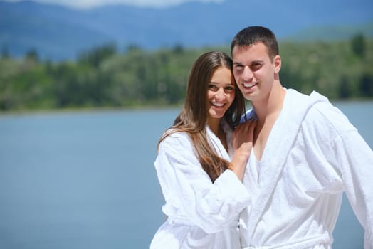 Romantic young couple spending time together and relaxing on yacht