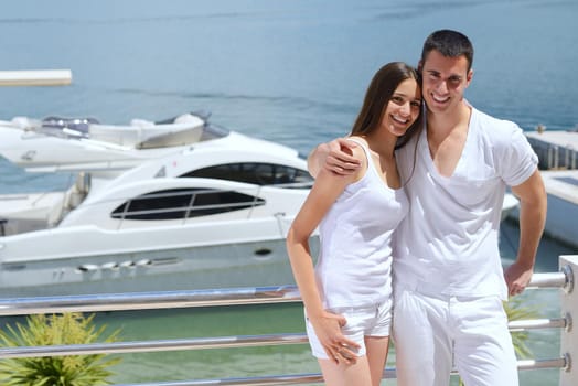 Romantic young couple spending time together and relaxing on yacht