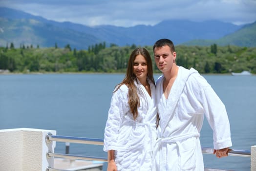 Romantic young couple spending time together and relaxing on yacht