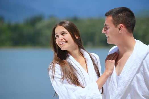 Romantic young couple spending time together and relaxing on yacht