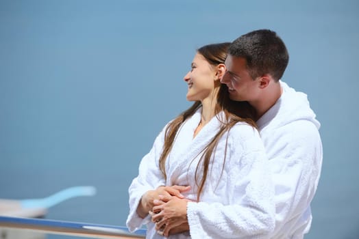 Romantic young couple spending time together and relaxing on yacht