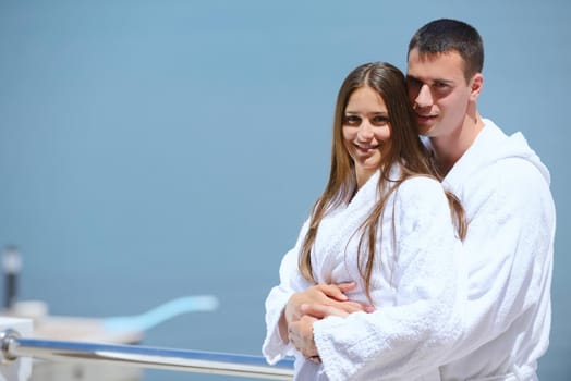 Romantic young couple spending time together and relaxing on yacht