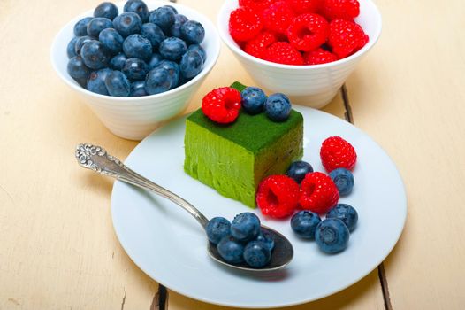 green tea matcha mousse cake with raspberries and blueberries on top