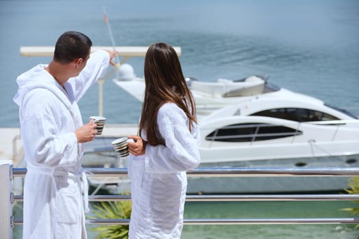 Romantic young couple spending time together and relaxing on yacht