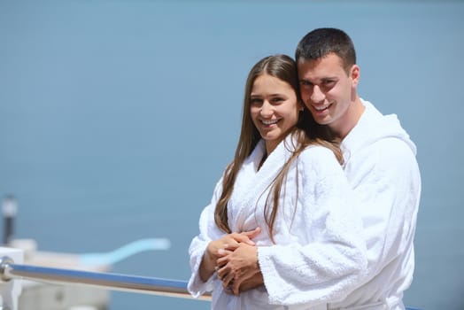 Romantic young couple spending time together and relaxing on yacht