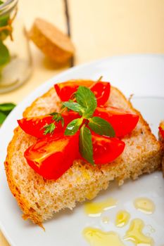 Italian tomato bruschetta with thyme and mint leaves 