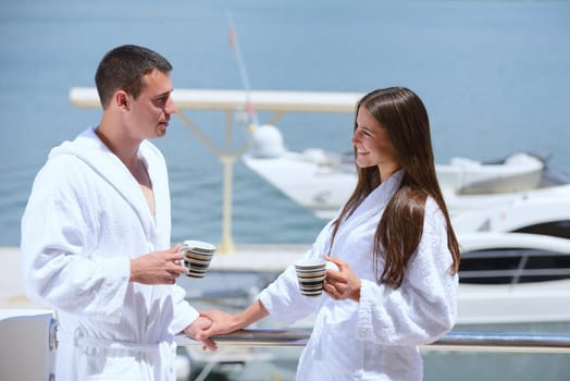 Romantic young couple spending time together and relaxing on yacht