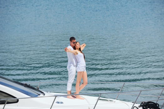 Romantic young couple spending time together and relaxing on yacht