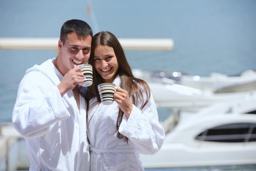 Romantic young couple spending time together and relaxing on yacht