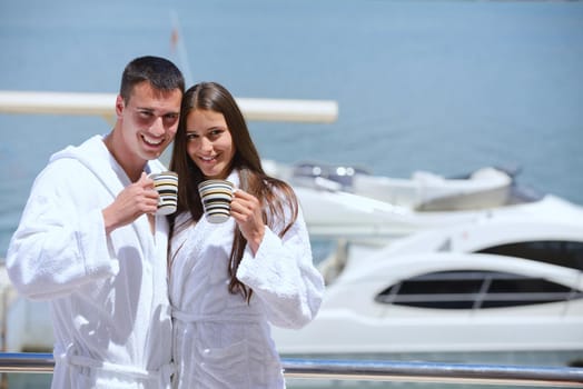 Romantic young couple spending time together and relaxing on yacht