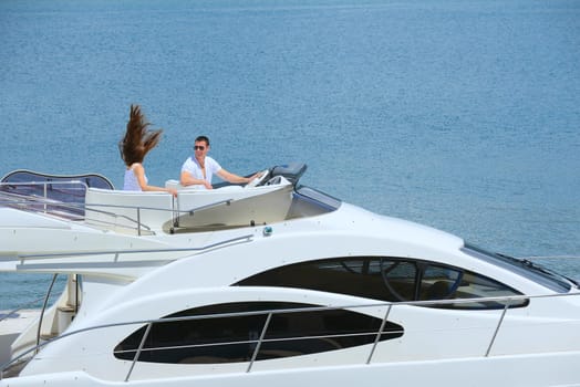 Romantic young couple spending time together and relaxing on yacht