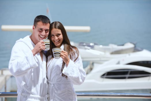 Romantic young couple spending time together and relaxing on yacht