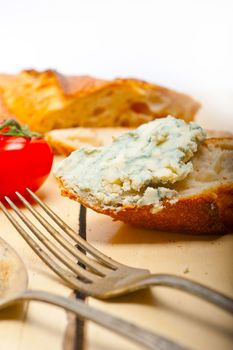 fresh blue cheese spread ove french baguette with cherry tomatoes on side