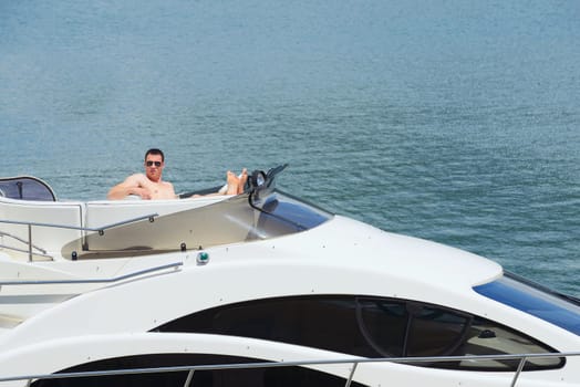 Romantic young couple spending time together and relaxing on yacht