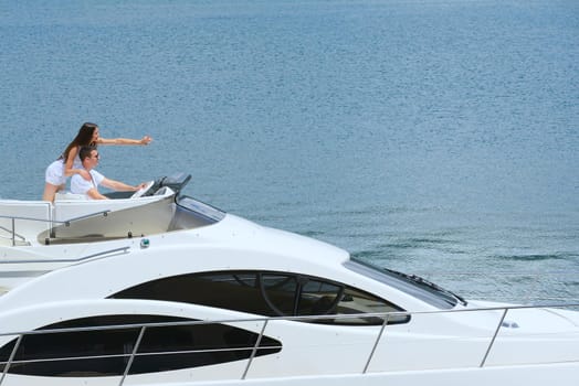 Romantic young couple spending time together and relaxing on yacht