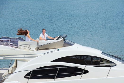 Romantic young couple spending time together and relaxing on yacht