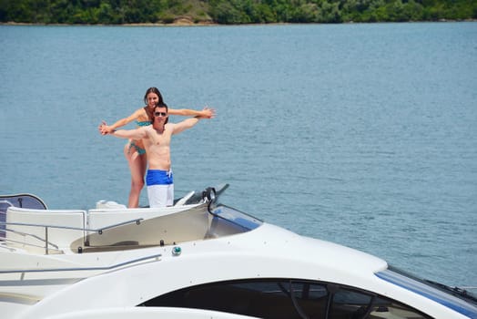 Romantic young couple spending time together and relaxing on yacht