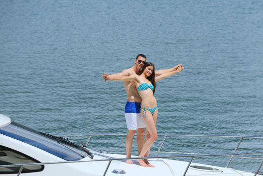 Romantic young couple spending time together and relaxing on yacht