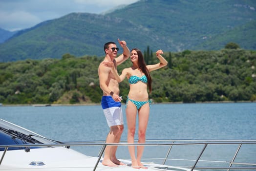 Romantic young couple spending time together and relaxing on yacht