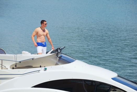 Romantic young couple spending time together and relaxing on yacht