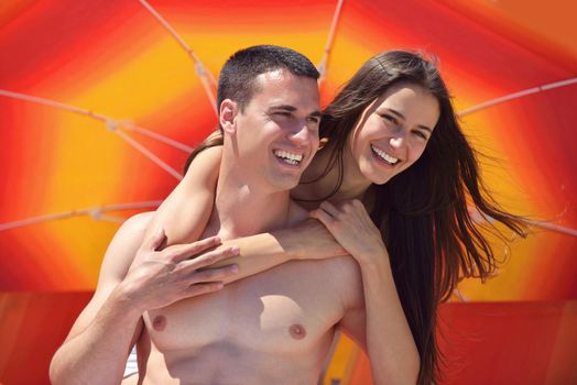 happy young couple have fun and relax  on the beach