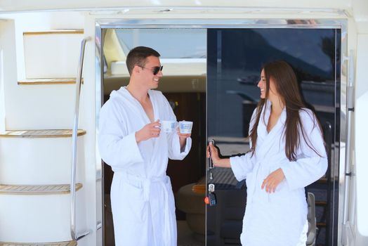 Romantic young couple spending time together and relaxing on yacht