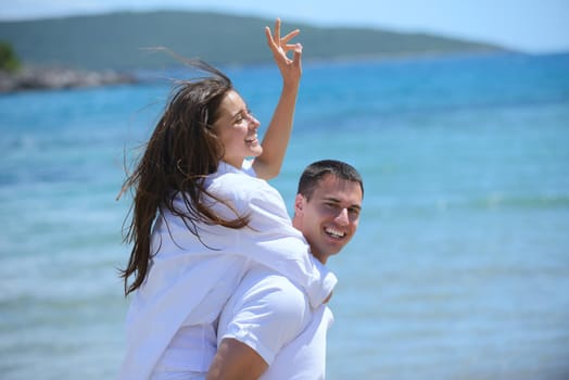 happy young romantic couple in love have fun running and relaxing on beautiful beach