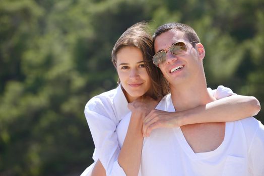 happy young couple have fun and relax  on the beach