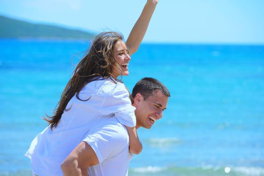 happy young couple have fun and relax  on the beach