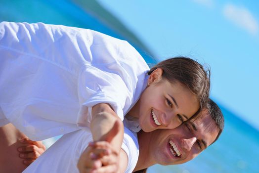 happy young couple have fun and relax  on the beach