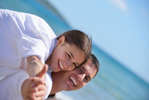 happy young couple have fun and relax  on the beach