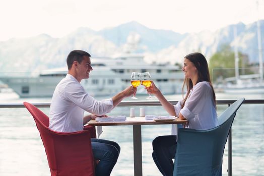 happy young couple having lanch at beautiful restaurant on by the sea on  beach