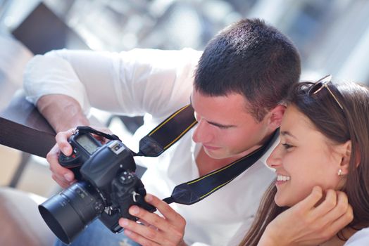 happy young romantic couple looking photos on camera