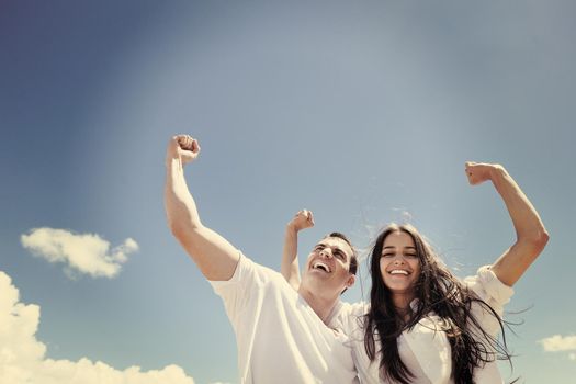 happy young couple have fun and relax  on the beach