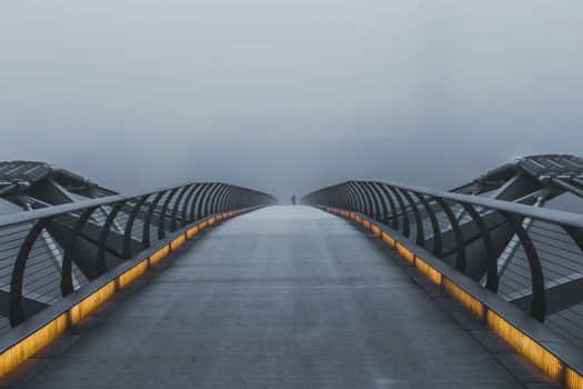 London's Millennium Bridge on a morning of heavy fog - monochrome with selective colour