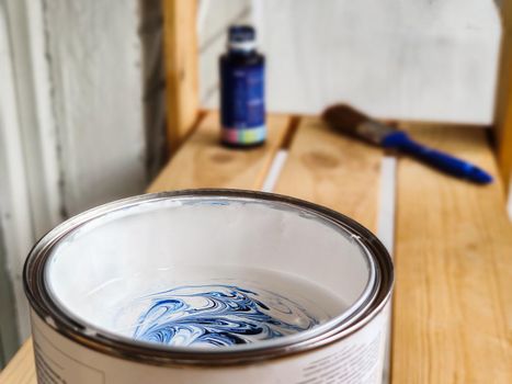 Mixing white and blue paint to paint walls or furniture. Home renovation and design.
