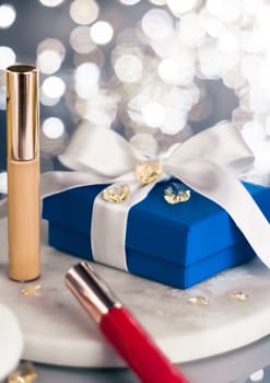 Cosmetic branding, Christmas glitter and girly blog concept - Holiday make-up foundation base, concealer and blue gift box, luxury cosmetics present and blank label products for beauty brand design